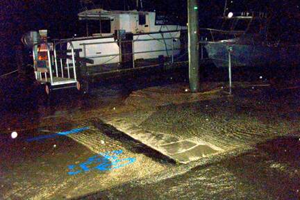 INUNDATION: The footpath at the Narooma wharf is flooded during a recent king tide...