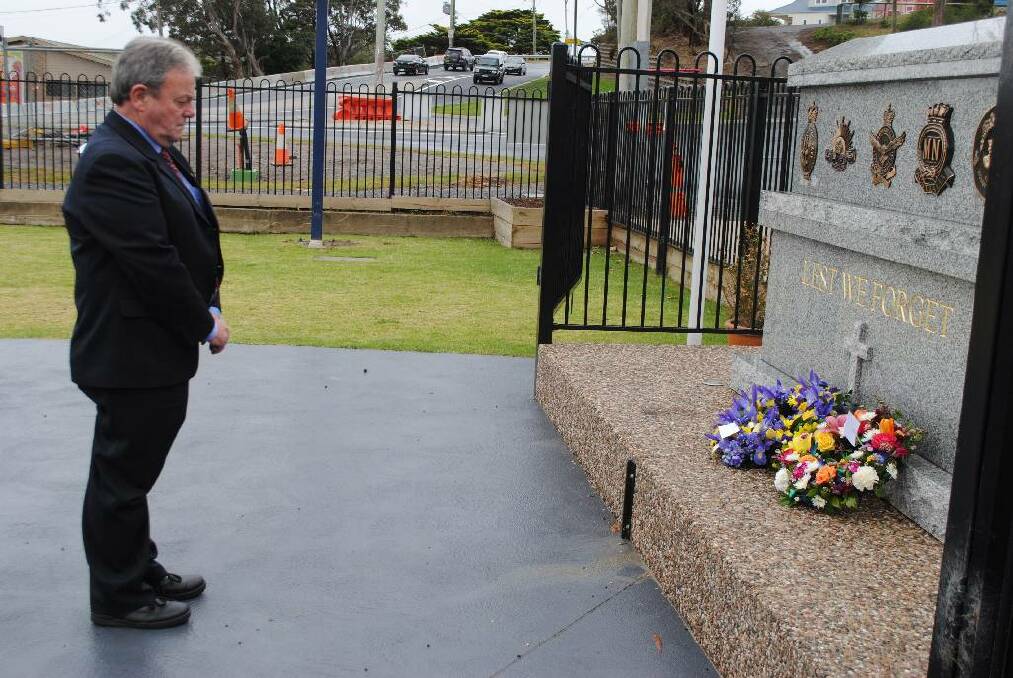 COUNCIL REP:  Deputy mayor of Eurobodalla Shire Council, Neil Burnside lays a wreath to honour veterans at the Remembrance Day ceremony at Club Narooma. 
