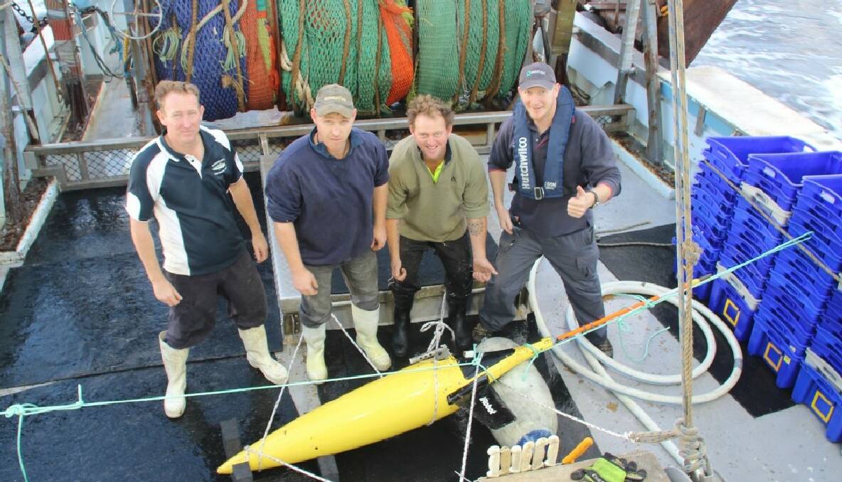 THE CREW: The crew of the Shoalhaven 70' trawler skipper Andrew Wintle and deckies Michael Franks and Gary Bray with oceanographer Stuart Milburn from NSW-IMOS, UNSW and the “Dory” seaglider. 