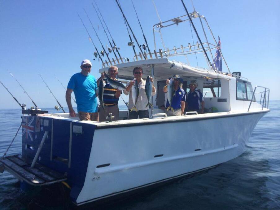 LIGHTHOUSE CHARTER: Skipper Warren "Wazza" Atkinson and his happy clients at Montague Island on Saturday morning with their kingfish haul.