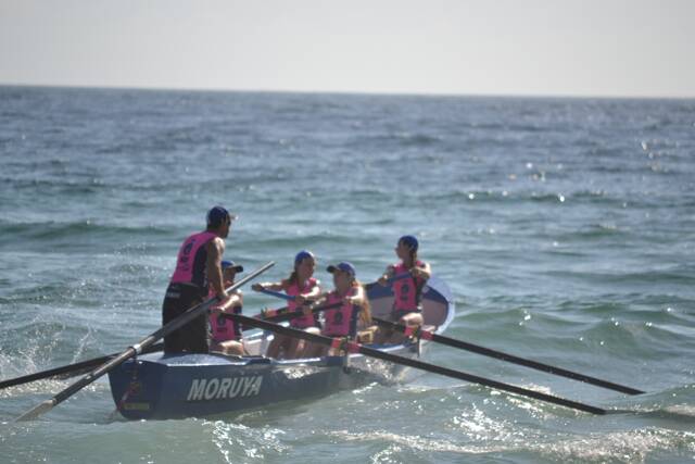 SURF ACTION: The Moruya girls head off on another surfboat sprint race. Photo by Stan Gorton – Narooma News 