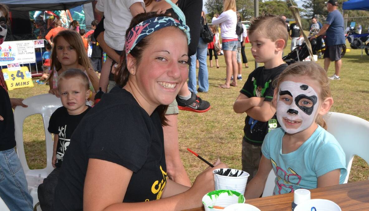 FACE PAINTING: Madeleine Sing of Tumut paints the face of Liana Hummel from Brisbane. 