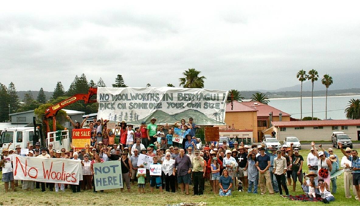 PROTEST PICNIC: Opponents of the proposed Woolworths gathered at the site on Sunday with lots of signs and songs to sing.