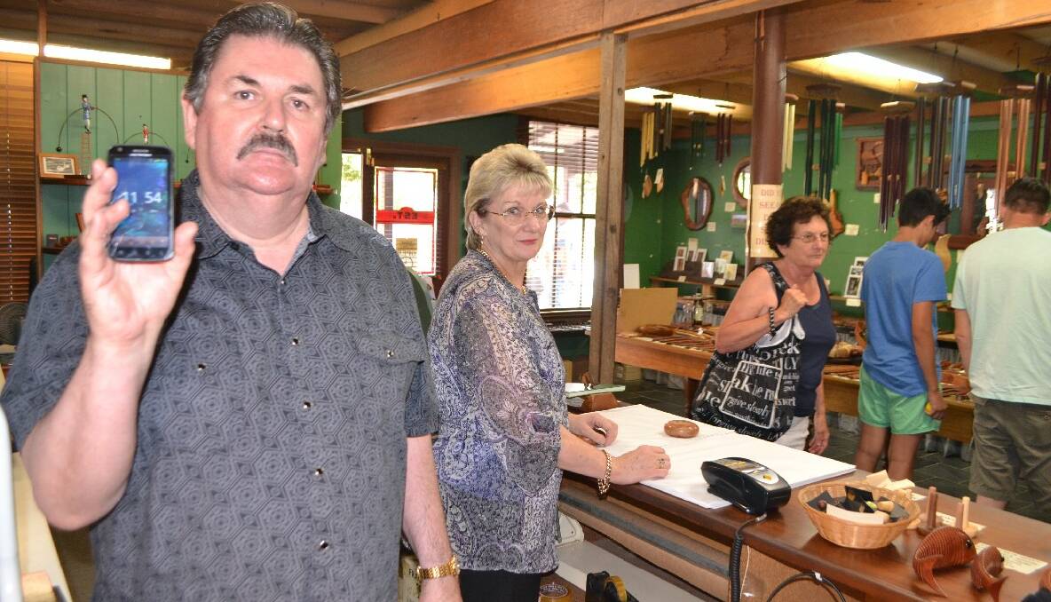 MOBILE WOES: Running a business and serving tourists is made that much harder without any mobile service, according to Central Tilba business owners George and Barbara Davies, pictured in their shop The Tilba Woodturning Gallery. 