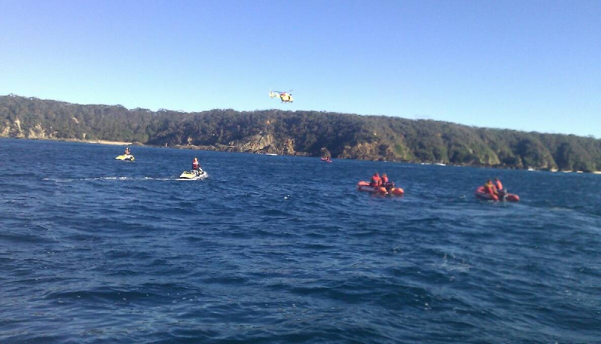 INSHORE OPERATION: The flotilla of rubber duck and JetSki’s take off to find the missing dummies with the Westpac Life Saver 3 flying overhead. Photo by Julia Mayo-Ramsey 