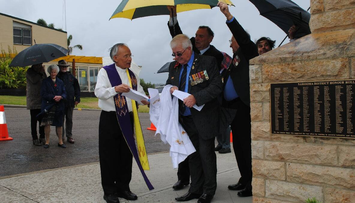 BLESSING:  Father Tran blessed the new plaque at the dedication ceremony of the new plaque honouring WWII veterans from the area. Pictured with Paul Naylor Narooma RSL sub-branch president Paul Naylor. 