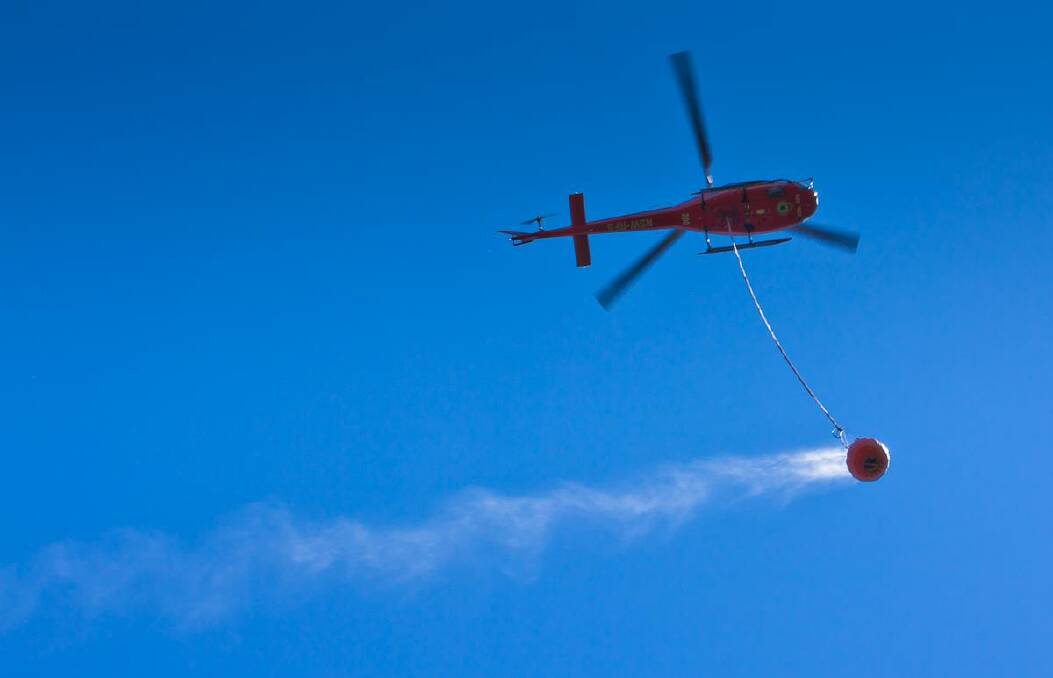 OVER YOU: Cobargo based photographer Warren Purnell from Over U Photography snapped this shot of the RFS Firebird 200 helicopter over the Yowrie fire on Tuesday. 