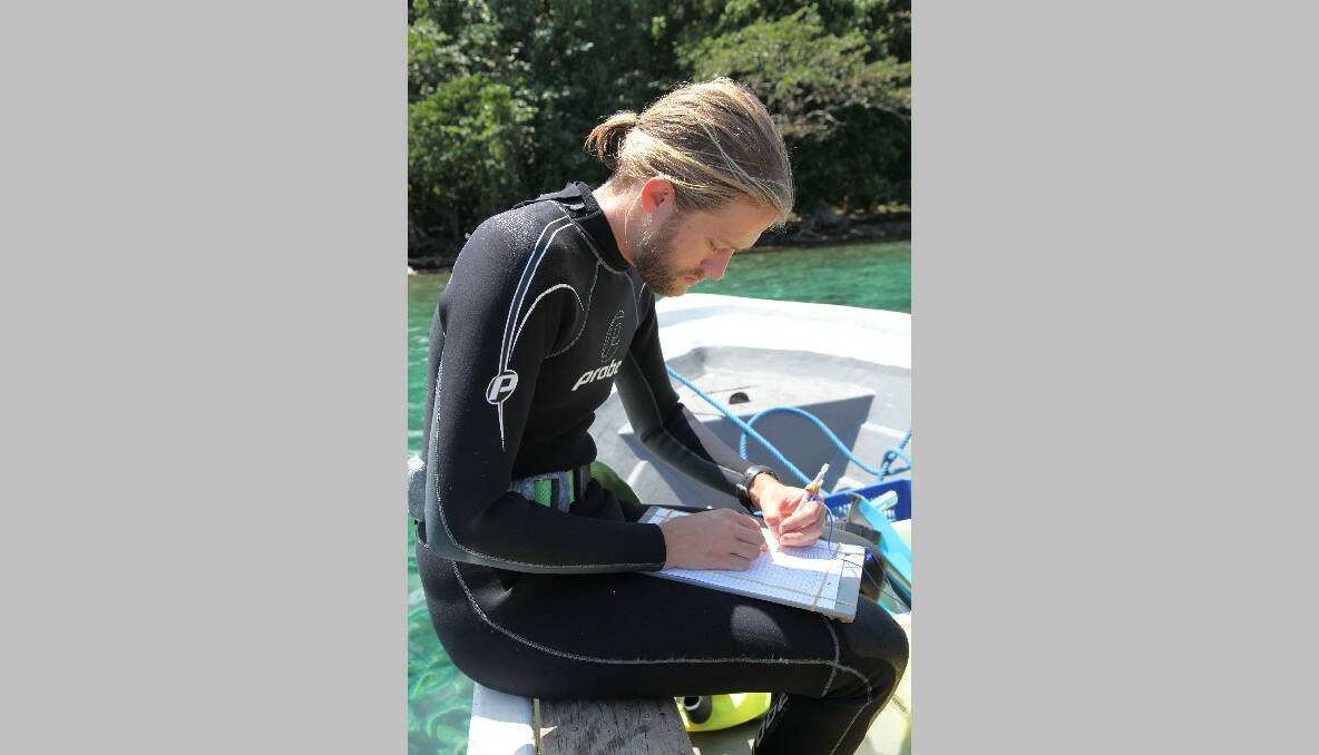 AT WORK: Australian Institute of Marine Science marine biologist at work off PNG. Photo by Sally Ingleton 