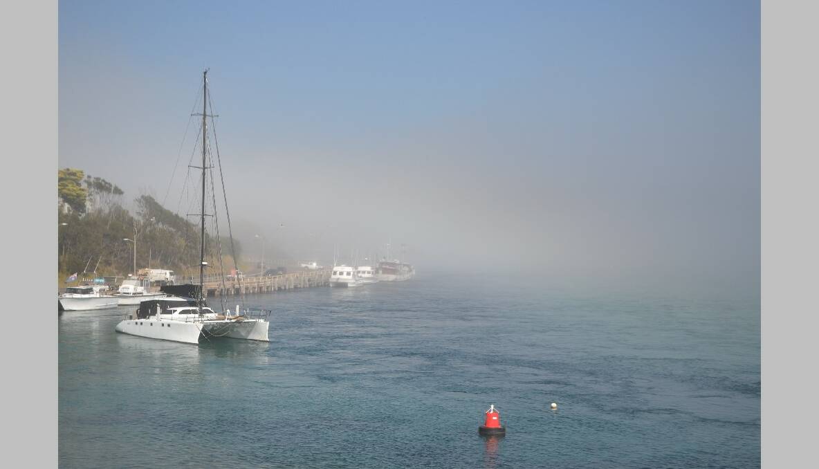 WHARF REVEALED: The fog lifts on Thursday morning to reveal the Narooma town wharf. Photo by Stan Gorton
