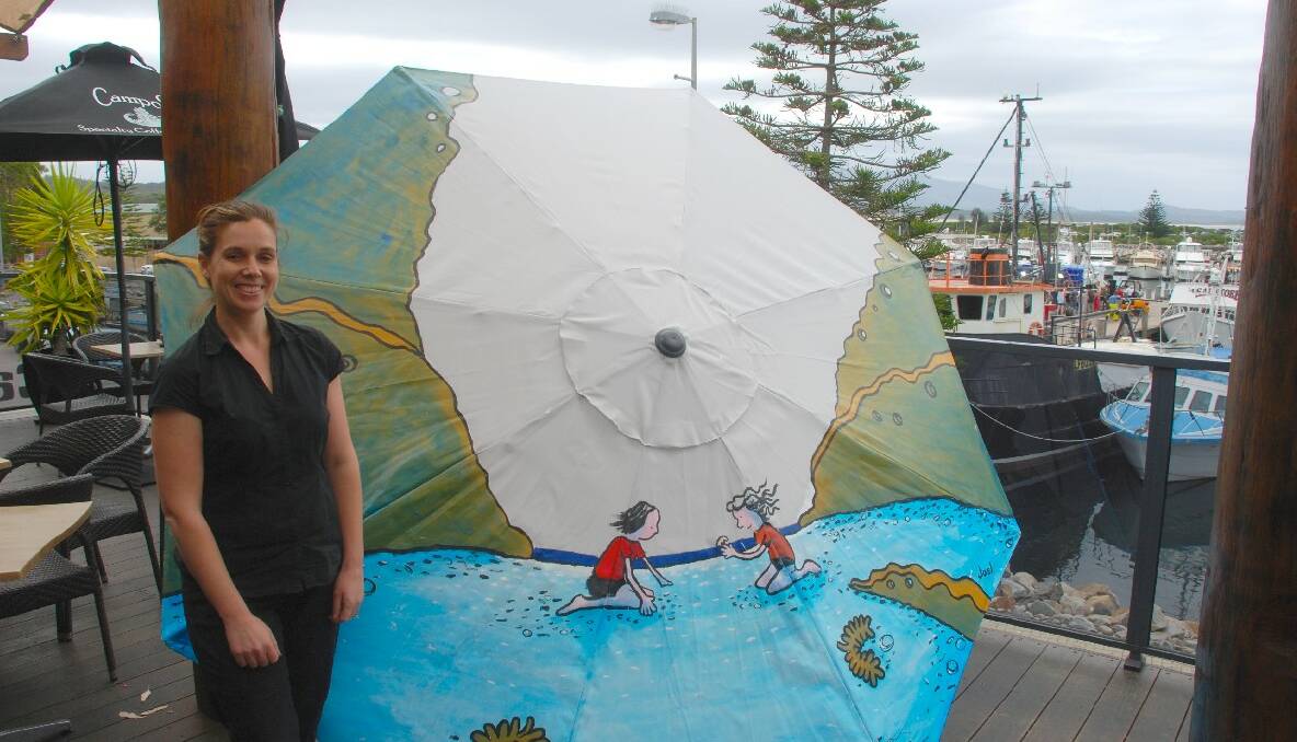 UMBRELLA 1: Sponsor Kate Power, proprietor of The Sundeck Restaurant at Fishermen's Wharf Bermagui, and her umbrella. 