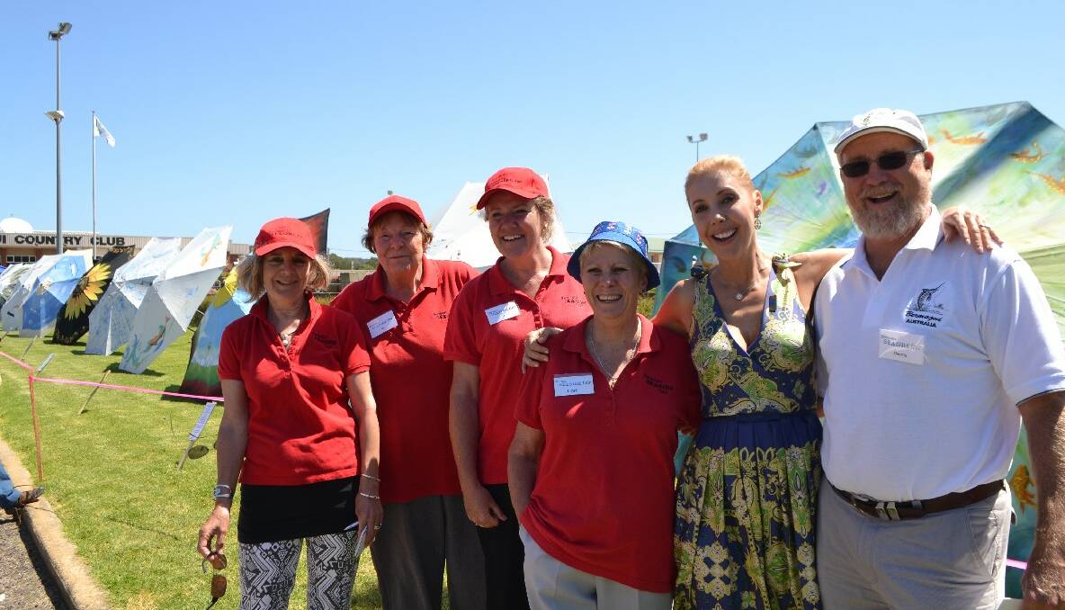 CATRIONA AND COMMITTEE: Bermagui Seaside Fair committee members Denise Page, Bev Fleming, Jo Jacobs and Lori Hammerton with Catriona Rowntree and the coordinator of the Umbrellas of Bermagui event Dennis Olmstead. 
