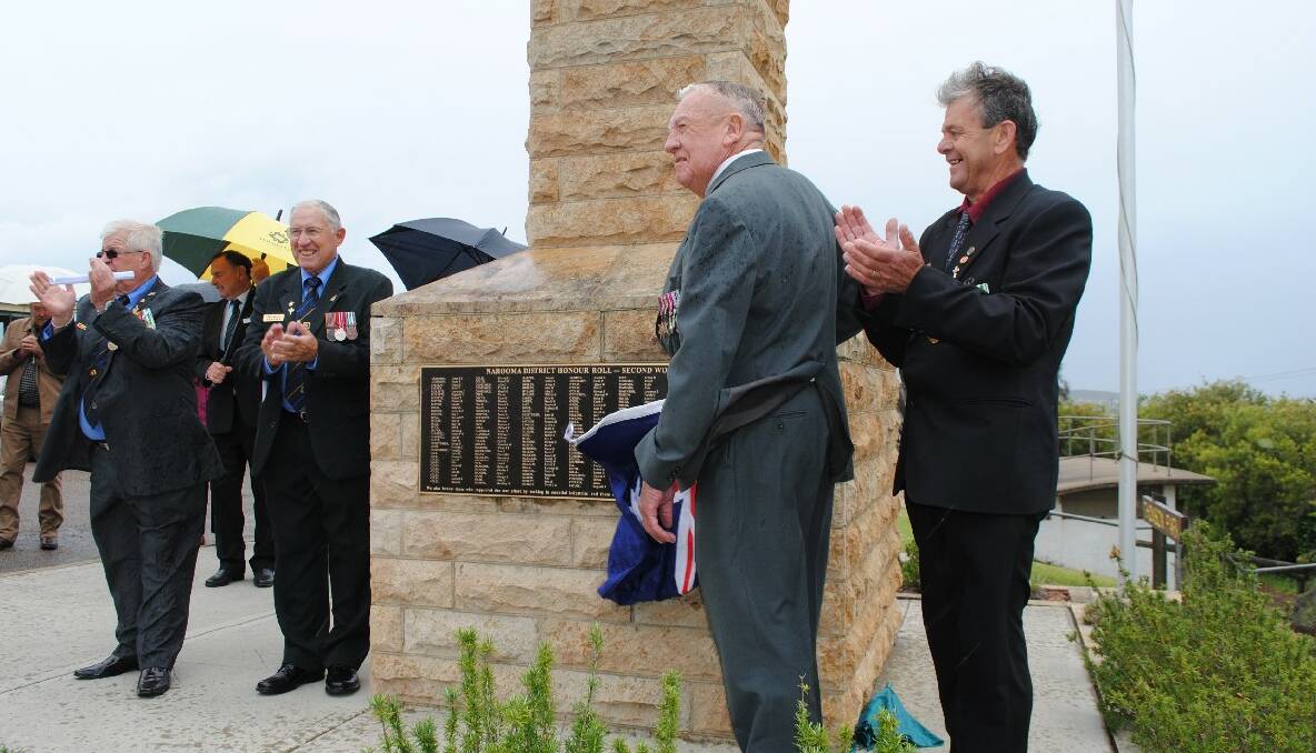 UNVEILING: Jim Pollock (centre) unveils the new plaque dedicated to the veterans from WWII that come from the local area. He is watched by Narooma RSL sub branch president, Paul Naylor (left), Jon King and Trevor Bennett (right). 