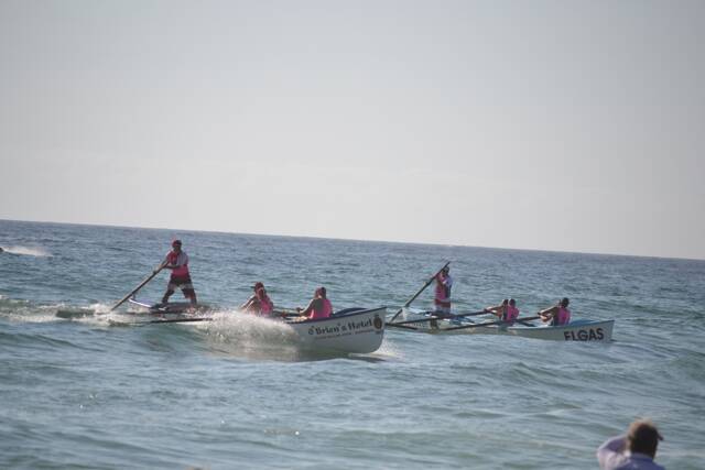 SURF ACTION: One of Narooma SLSC surfboat teams comes home in the sprints ahead of the Broulee Surfers. Photo by Stan Gorton – Narooma News 