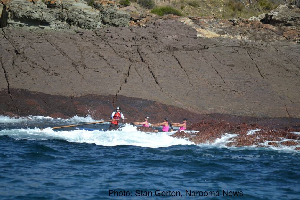 Narooma rounds the point out of Twofold Bay, Eden in perfect rowing conditions. Photo: Stan Gorton, Narooma News