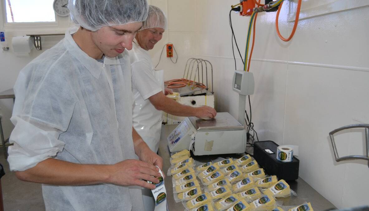 PACKING: A young Dibden and employee Glenn Bywater packing cheese.