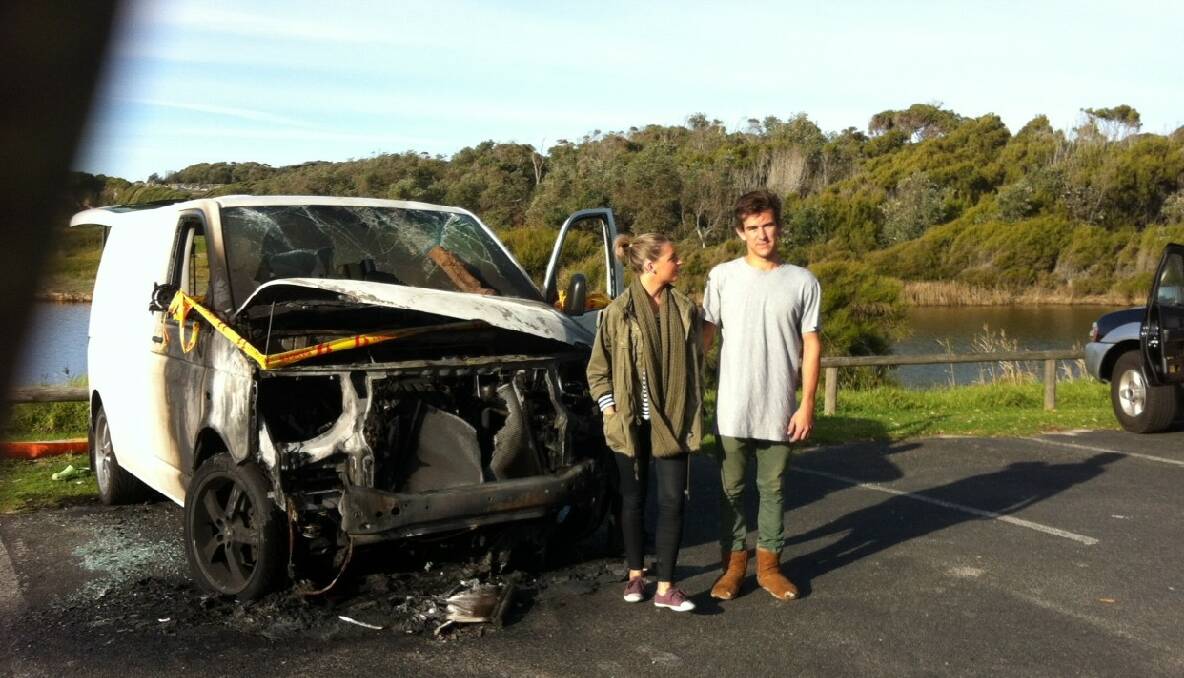 NOT TURNED OFF: Mikayla and Aaron from Wollongong in front of the van that was vandalised after catching the fire the night before. 