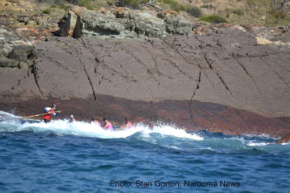 Narooma rounds the point out of Twofold Bay, Eden in perfect rowing conditions. Photo: Stan Gorton, Narooma News