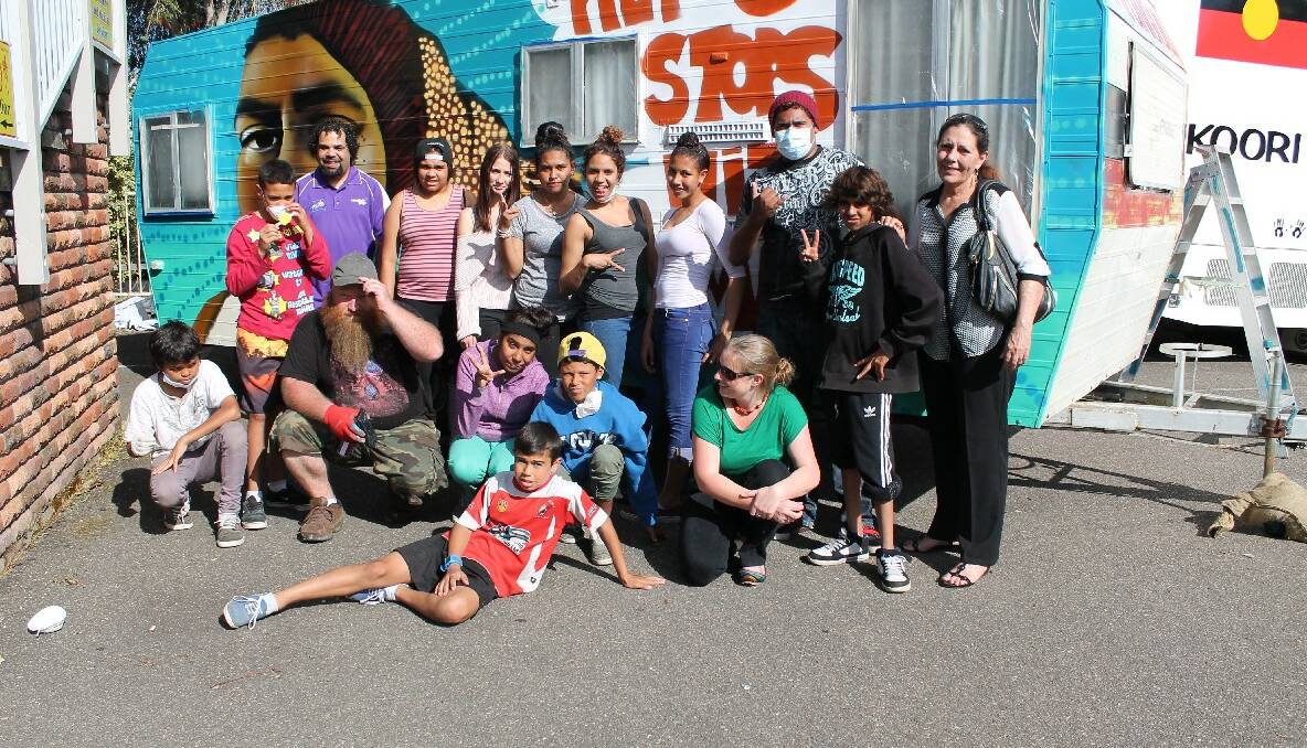 OUR MOB: Graffiti artist Ash Johnston with the youth who are now peer educators after completing the “Your Mob, My Mob, Our Mob” program. 