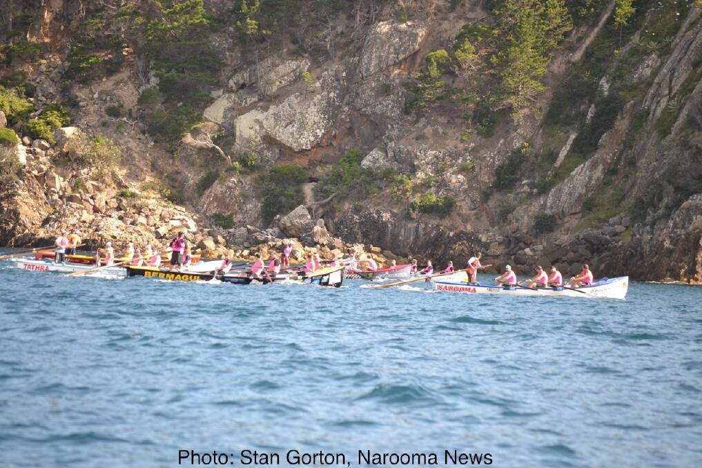 Hugging the coast of Twofold Bay at Eden, the veteran men races in a tight pack. Photo: Stan Gorton, Narooma News