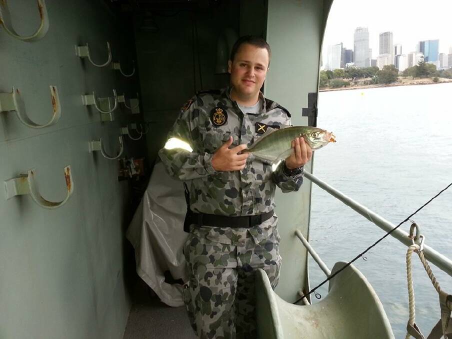 FISHING SAILOR: Able Seaman Owen Gauslaa with a nice trevally he caught this week during his time off on board his ship HMAS Stuart, moored at Garden Island, Sydney. 