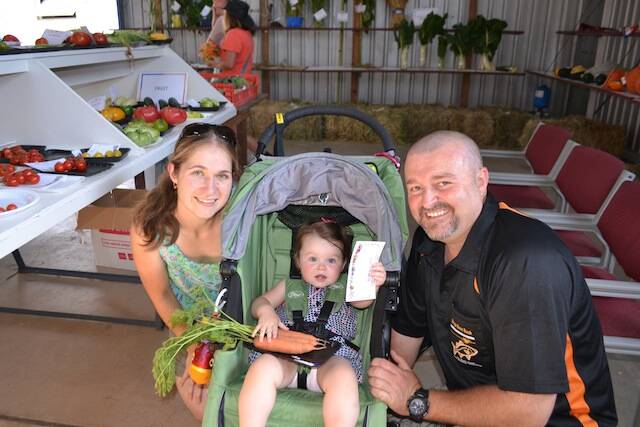 LITTLE GARDENER: Little Breonie Martin of Bermagui won first place for her carrots and is pictured with her parents Niki and Patto.