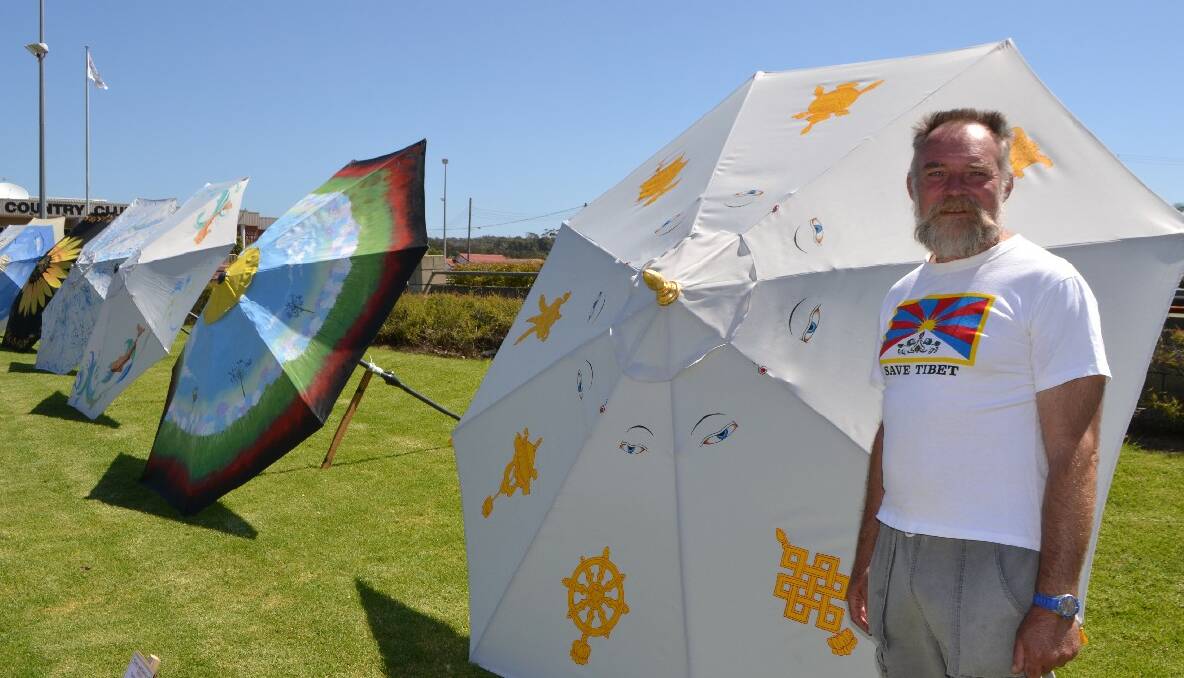 TIBET MESSAGE: Local artist Paul Fletcher’s Tibet-themed umbrella stuck a chord with Catriona who herself as travelled to the troubled region. 