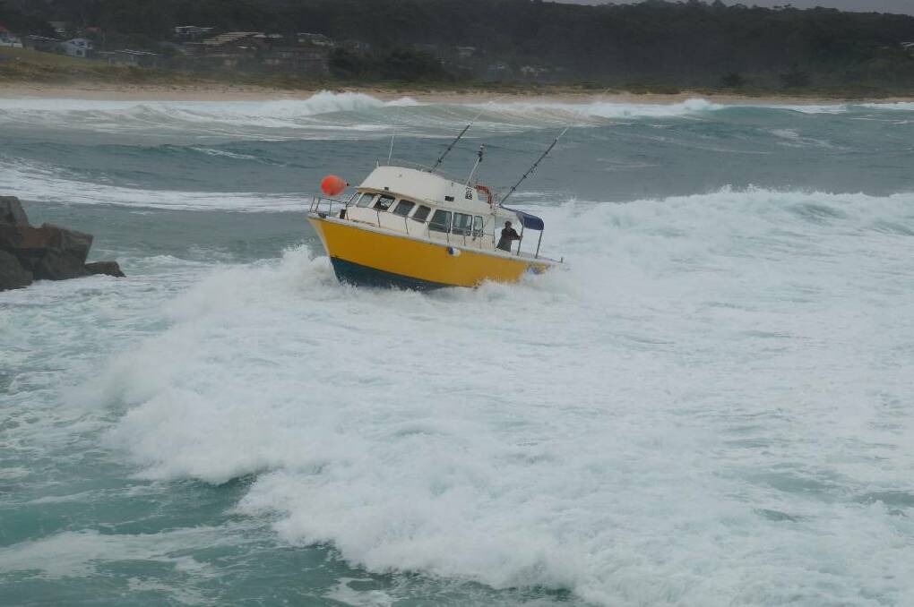 ROUGH SEAS: Still photos of the charter boat that nearly capsizes coming into Bermagui Harbour on Monday.